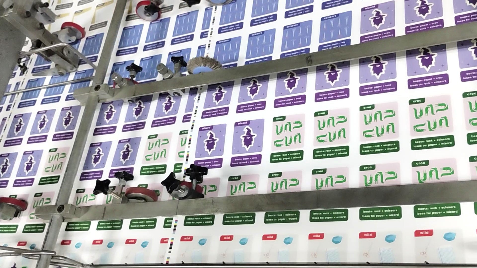 Sheet of 100 uncut cards shown moving through an offset printing press in Michigan.