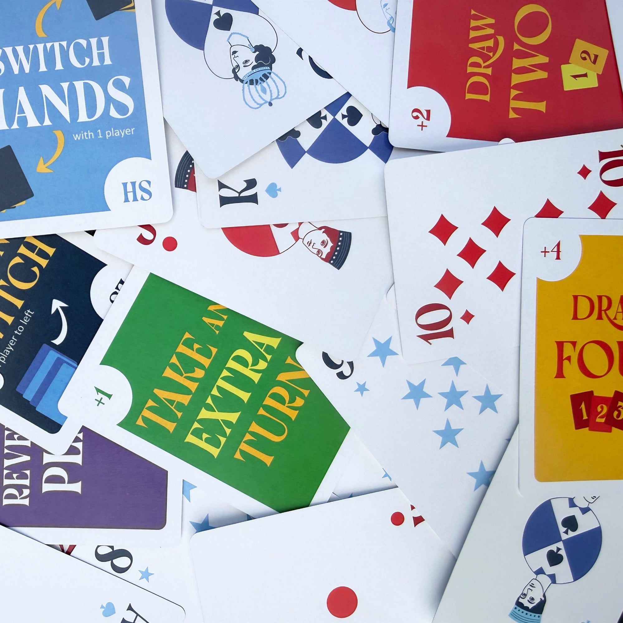 Collection of colorful Stack the Deck game cards with various text and symbols 
