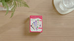 Game unboxing video with opening of box, showing of fronts and backs of different playing cards.